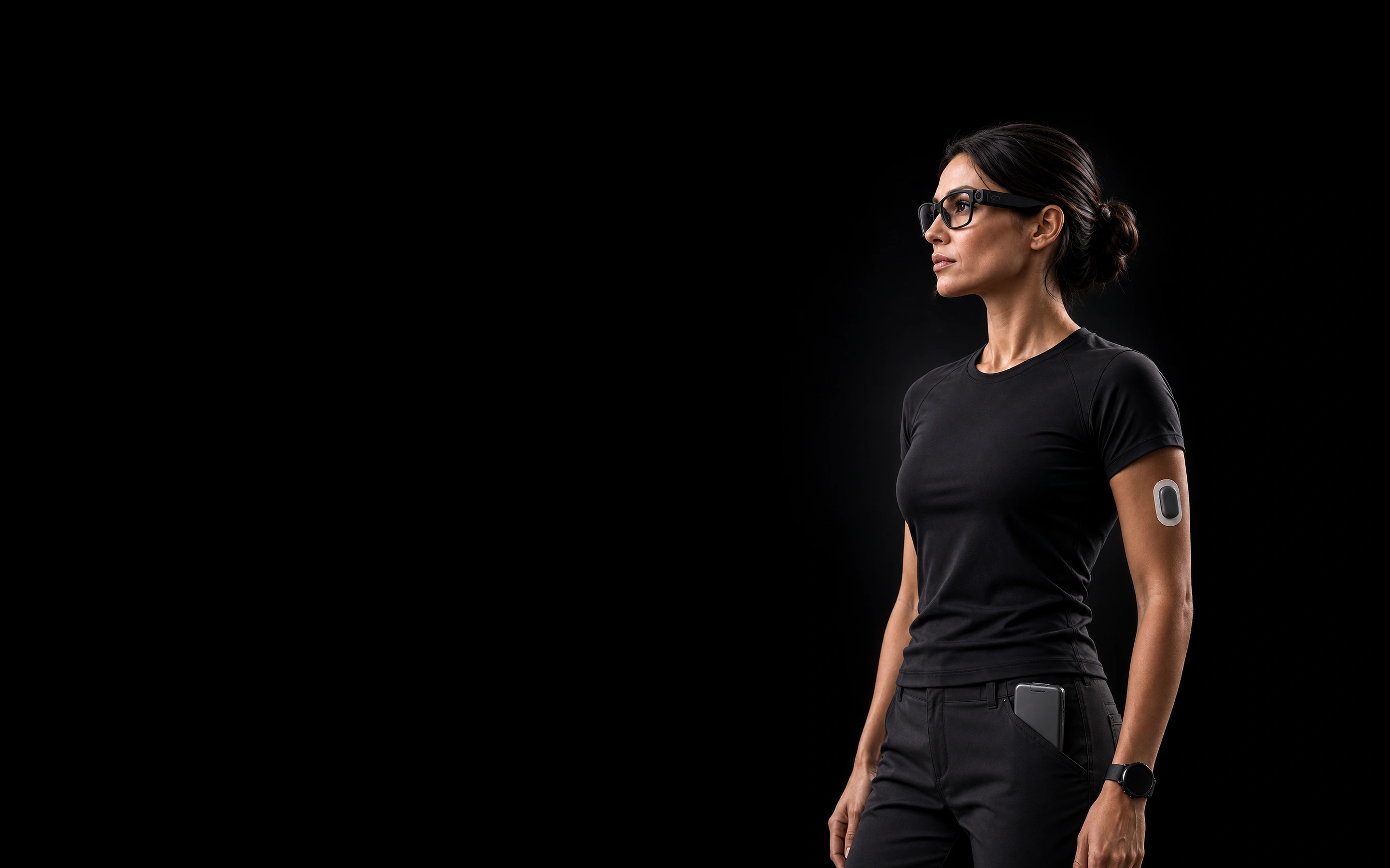 Woman wearing smart glasses, a wearable sensor, a watch, and a pocket compute device.