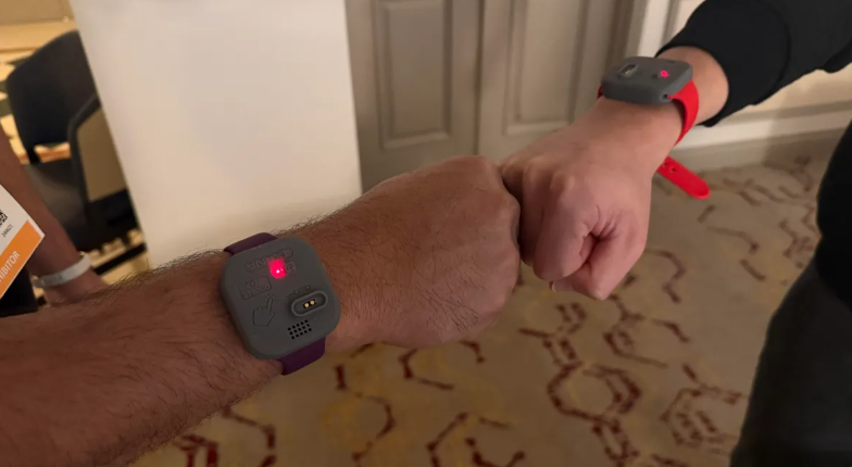 Fist-bump data transfer: Wearables sync on contact.